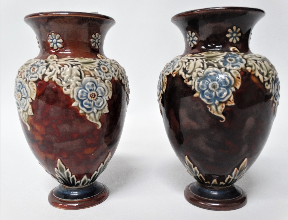 A pair of Doulton Lambeth small baluster vases with foliate applied decoration, height 15cm.