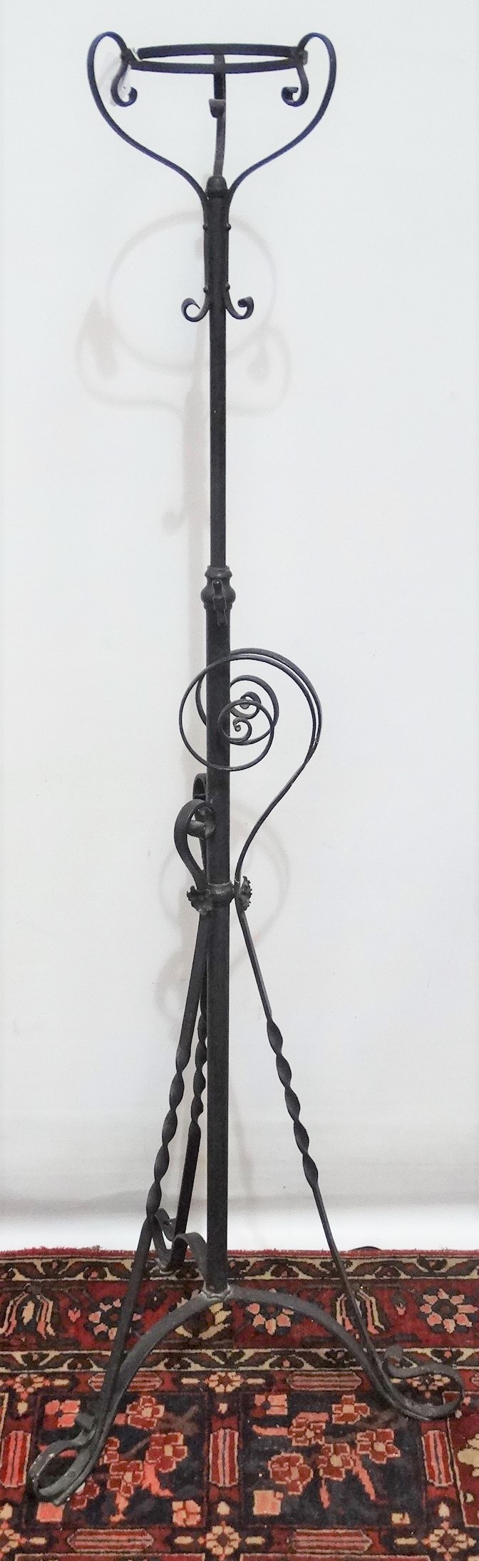 A late 19th century wrought iron oil lamp stand in Gothic taste.