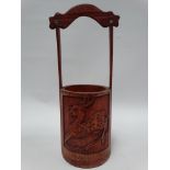 A Chinese bamboo pail brush pot, one side carved with a deer, the other a blossoming branch,