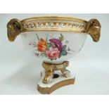 An early 19th century Crown Derby centrepiece, of ovoid section with three applied ram's head