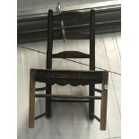 An early 19th century ladder back country chair.