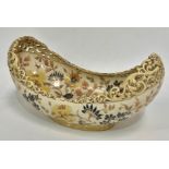 A Zsolnay Pecs pottery boat shaped vase with pierced foliate scroll rim and with foliate