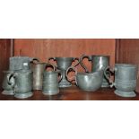 A collection of 19th century pewter mugs, a twin handled trophy and a gravy boat.