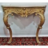 A 19th century carved and gesso giltwood console table raised on cabriole C scroll supports with