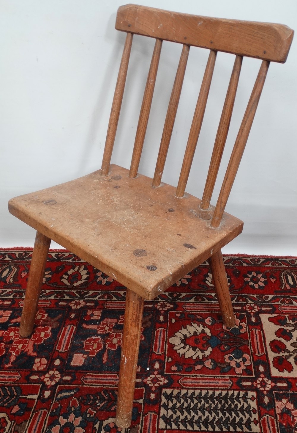 A late 18th or early 19th century stickback chair in sycamore and ash, possibly West Country.