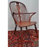 A 19th century yew and elm Windsor armchair with bow stretcher.