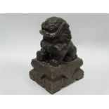 A Chinese green soapstone Buddhistic lion upon rectangular stepped base, height 15.5cm.