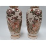 A good pair of Japanese Satsuma vases, decorated with blossoming trees, both signed to the base,