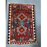 A modern middle eastern hand knotted wool rug decorated with four deer to the corners with two