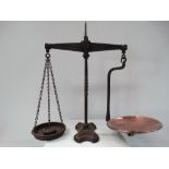 Cast iron balance scales with a copper tray and various stacking weights, height 46cm.