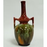 An early 20th century twin handled bottle vase after Christopher Dresser with pink and running green