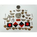 A collection of military badges and buttons, including pips inscribed 'TRIA JUNCTA IN UNO' for guard