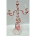 A German porcelain four branch candlestick with mother and child figural base, underglaze blue JR