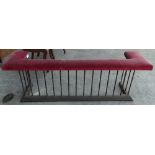 A 19th century wrought iron stuffover upholstered club fender with pink velvet upholstered seat,