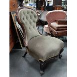 A Victorian mahogany and upholstered occasional chair with cabriole legs and button back.