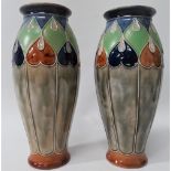 A pair of Royal Doulton stoneware vases with tubelined decoration, No.7760E, height 24cm.