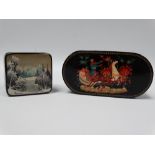 Two 20th century Russian black lacquer painted hinge lidded boxes, one painted with a troika to