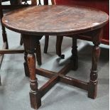 An oak framed circular occasional table.