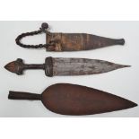 A North African leather covered dagger with engraved leaf shaped blade, length 42cm, together with a