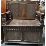 An oak and panelled Tudor style monk's bench, width 88cm.