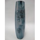 A Carn Pottery Penzance vase tubline decorated with a stylised sunflower, height 28cm.