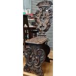 A 19th century Italian walnut Sgabello hall chair, the back carved with a crown surmount over an