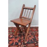 A late 19th century mahogany framed child's folding chair.