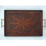 A Victorian Arts & Crafts mahogany rectangular brass twin handled tray, the centre with star and