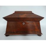 A rosewood sarcophagus form work box, the lid hinged to reveal a lift out tray with compartments,