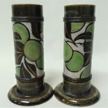 A pair of Royal Doulton stoneware cylindrical vases with a spread foot, with a band of incised