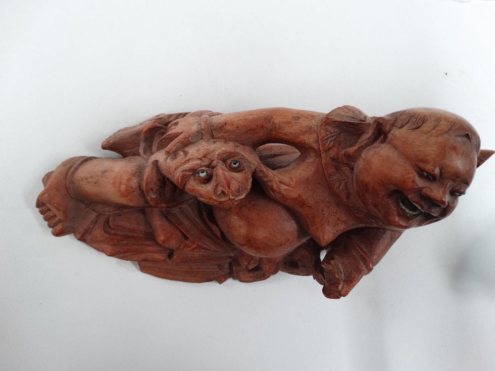 A Chinese root carving, carved as a jovial portly gentleman with a frog, with glass eyes and ivory - Image 4 of 4