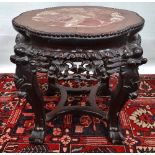 A Chinese hardwood and marble vase stand, the frame extensively carved with foliage and bird figures