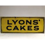 An early 20th century enamel on metal advertising sign for 'LYONS' CAKES', 46 x 122cm.