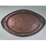 An interesting copper oval Arts & Crafts tray embossed with a serpent and lizard to the rim, the
