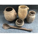 Four African carved wood pots and a spoon.