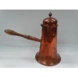 A 19th century copper chocolate pot with side turned wood handle, height 29.5cm.