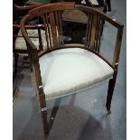 An Edwardian mahogany and inlaid armchair with upholstered seat and boxwood stringing.