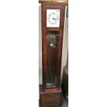 A mahogany cased floor standing electric clock, together with a box of parts, weight and pendulum,