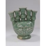 A Chinese celadon glazed five section tulip vase with moulded coiling dragon decoration, height