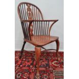 An elm and beech Windsor armchair with cabriole legs and bow stretcher.