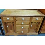A Victorian stripped pine side cabinet fitted six drawers and two cupboards with white ceramic