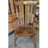 A late 19th century elm and beech stickback kitchen armchair.