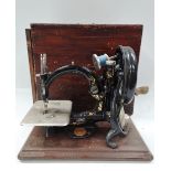 A small late 19th century manual sewing machine by Willcox & Gibbs Sewing Machine Co. New York