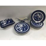 A collection of 19th century blue and white transfer printed 'Willow' pattern dinner wares,