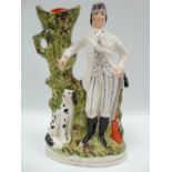 A Victorian Staffordshire Pottery flatback spill vase modelled as a hunter with hound by a tree