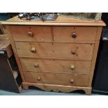 A stripped pine chest of five drawers on bracket feet, width 107cm.