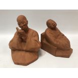 A pair of early 20th century French terracotta bookends by Gaston Hauchecorne, modelled as a pair of