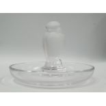 A Lalique glass pin dish with central frosted bird, inscribed 'Lalique France' to the base, diameter
