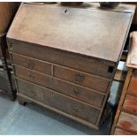 A mid 18th century small scale oak bureau with fitted interior, sliding well and four graduated