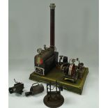 An early 20th century tin plate stationary steam engine, currently connected to an electric motor,